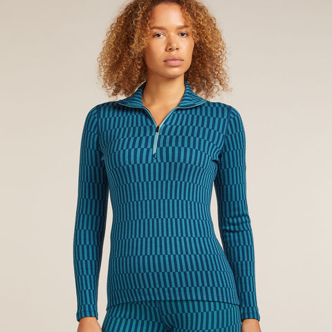Woman wearing a blue patterned outfit on a beige background