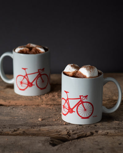 hot chocolate wit large marshmallows in gray mug with red bicycle print