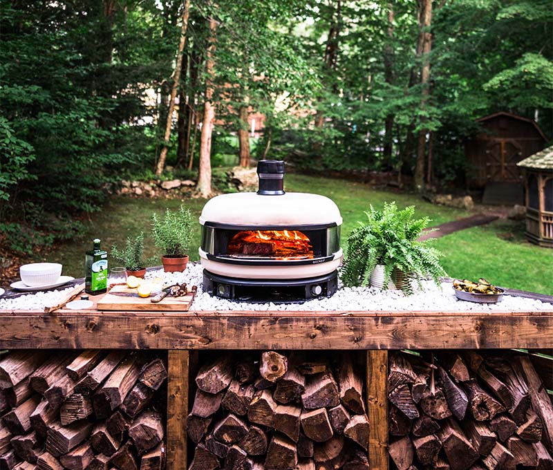 wisconsin backyard view of Gozney dome pizza oven on counter