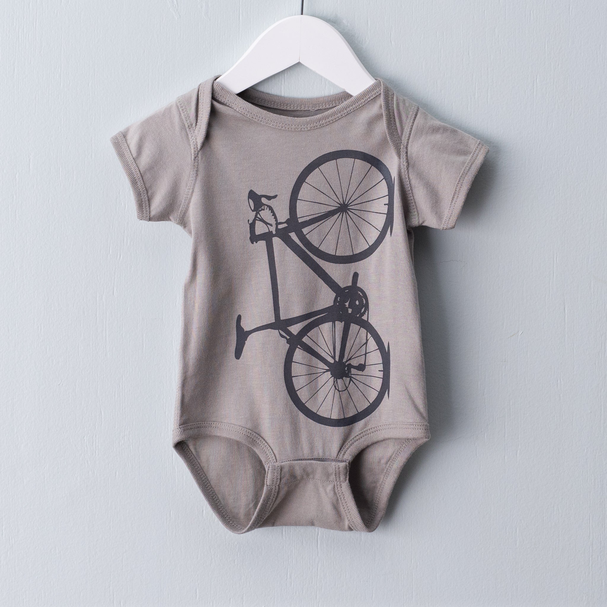 Titanium grey infant one piece screen printed with a warm grey tone bicycle