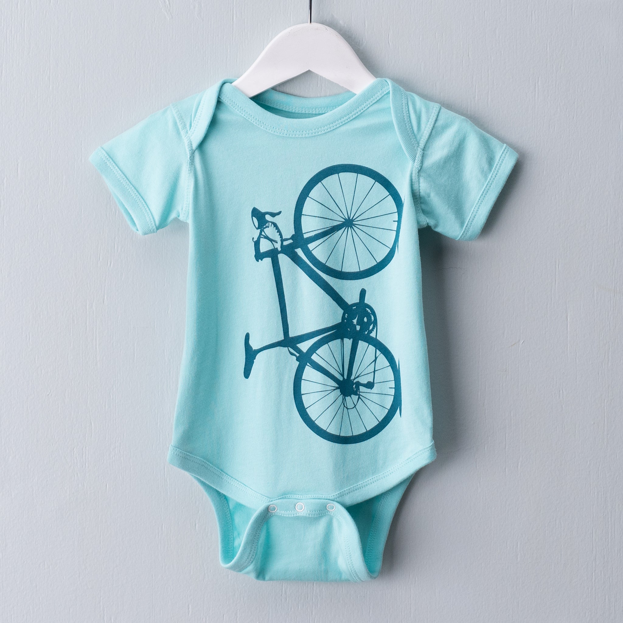 Chill blue infant one piece garment screen printed with a teal blue bicycle